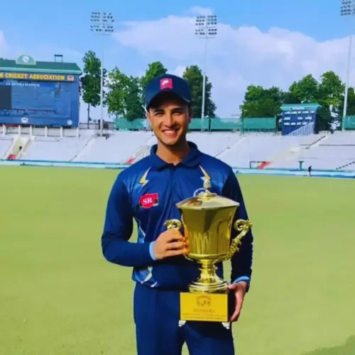 Abhishek Sharma holding a championship trophy while representing Punjab in domestic cricket