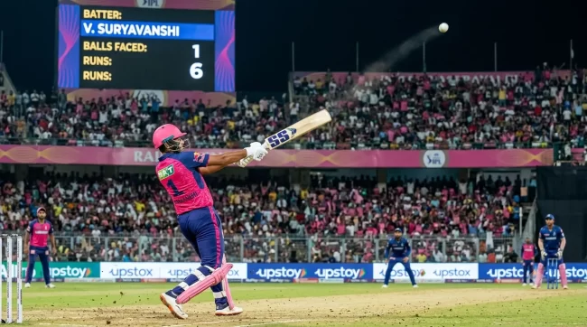 Vaibhav Sooryavanshi hits a six for Rajasthan Royals during an IPL match in a packed stadium.