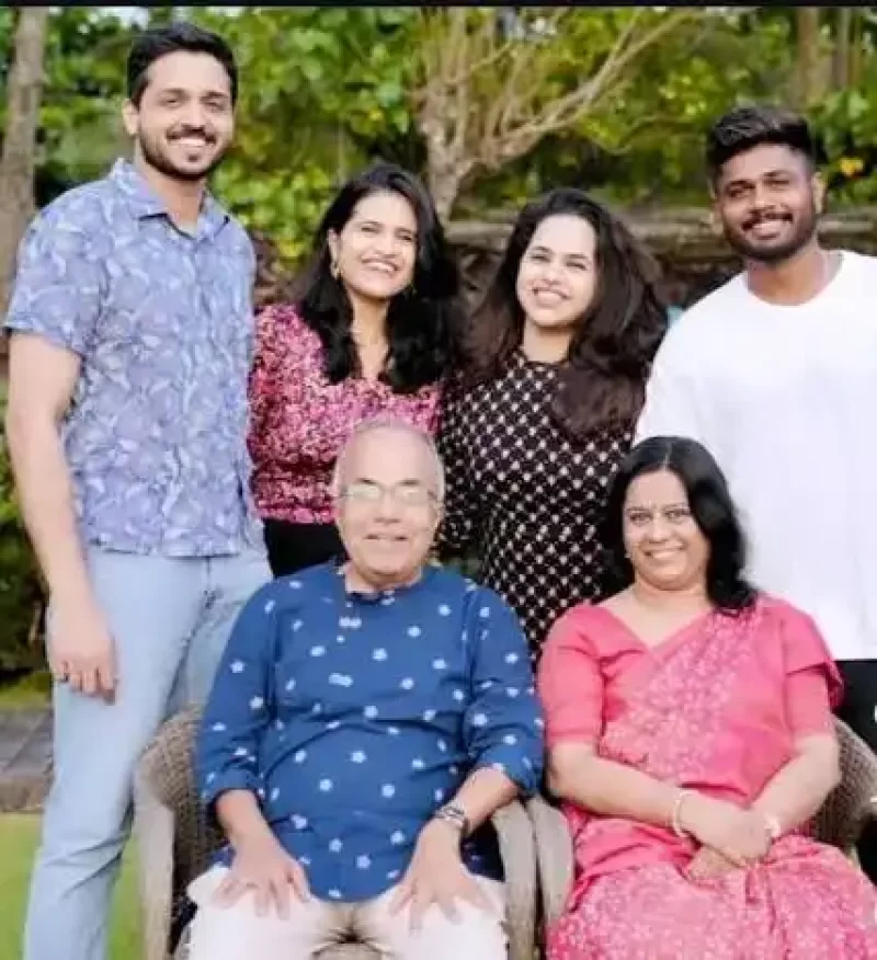 Sanju Samson posing outdoors with members of his family for a group photograph.