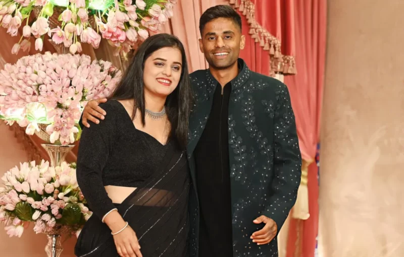 Suryakumar Yadav posing with his wife Devisha Shetty at a decorated family celebration in Mumbai.