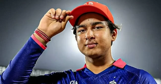 Vaibhav Sooryavanshi wears the IPL Orange Cap in a close-up portrait under stadium lights.
